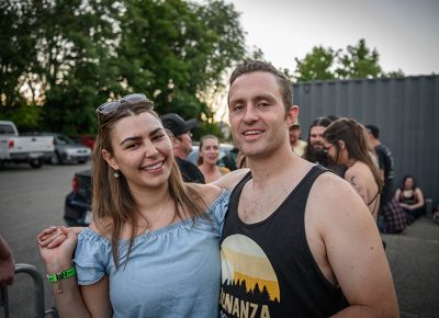 Smiles shine through as fans enjoy the cool evening weather during their queue up.