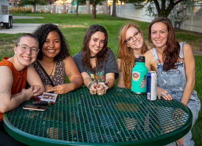 (L-R) Hannah Emery, Rachel Ostler, Makayla Dimond, Emily Vanderwilt and Brytni Leatherman found a lonely corner of the festival for a quick vape. Leatherwood is pretty happy with her purchase of a bottle that has some stickers on it.