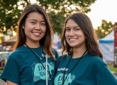 (L-R) STEM volunteers Elwin Kyi and Kaylynn Gonzalez take a break from the Google Fiber display to grab pops from the di Fruitta stand.