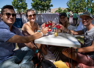 (L-R) Jose Cuaresma, Emily Christopher, Maddy Christopher and Scott Moffitt took advantage of the Maker’s Mark wax dipping station on the patio at the Harmons VIP Lounge.