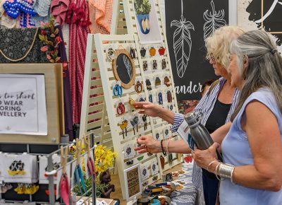 Shoppers admire the work of a talented artisan.