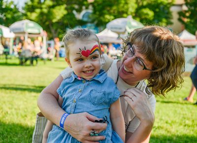 A little one gets her face painted at the Kids’ Area.