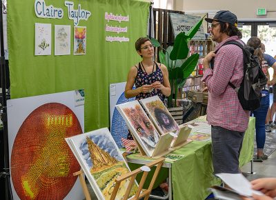 Clair Taylor talks art with an interested shopper.