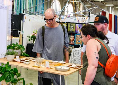 Shoppers look through a variety of handcrafted goods.