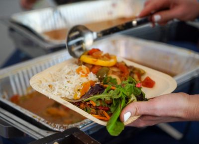 A attendee serving up a meal in the Harmons VIP Area.