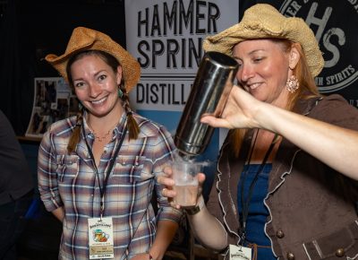 (L–R) Lulu Podratz and Vita Bernier work the Hammersmith booth as Bernier pours a Casper cocktail—their spooky take on a Vesper martini.