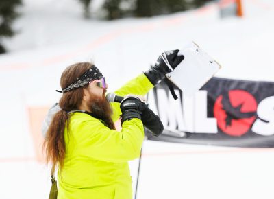 Host announcing tricks and numbers as the riders come down the hill at the SLUG 20th Anniversary Meltdown Games at Brighton Resort.