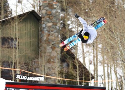 Skier in the air during a 360 barrel roll at the SLUG 20th Anniversary Meltdown Games at Brighton Resort.