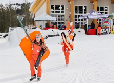 SLUG Team members lug the heavy wood and metal S L U G letters all the way up the hill at the SLUG 20th Anniversary Meltdown Games at Brighton Resort.