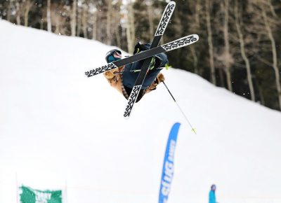 Skier flashes an X with his skis in the air off the jump at the SLUG 20th Anniversary Meltdown Games at Brighton Resort.