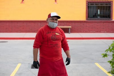 Red Iguana employee Israel Jimenez decked out in PPE gear to help with to-go food operations. He is one of the restaurant’s 200-plus employees whose jobs are endangered by the pandemic.