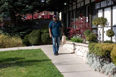 Employee Akhil T. walks happily away from the East India Cafe, to hand over some takeout. Beyond these operations, The Saffron Group has devoted significant resources to community service projects, including free meals for frontline workers.