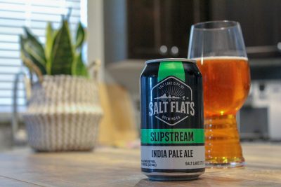 Spouting out of a vibrant green can, Slipstream IPA is a robust caramel color with a burnt-orange hue.