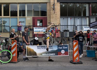 Davey Davis triumphantly takes his bike by the frame and hurdles an unsuspecting sign.