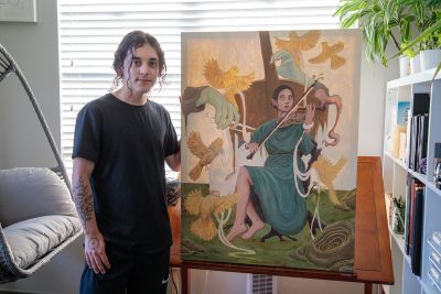 Hy Amenero poses with one of their stunning works.