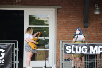 SLUG Managing Editor Bianca Velasquez introduces Cherry Thomas at the August SLUG Picnic. Photo: Erin Sleater