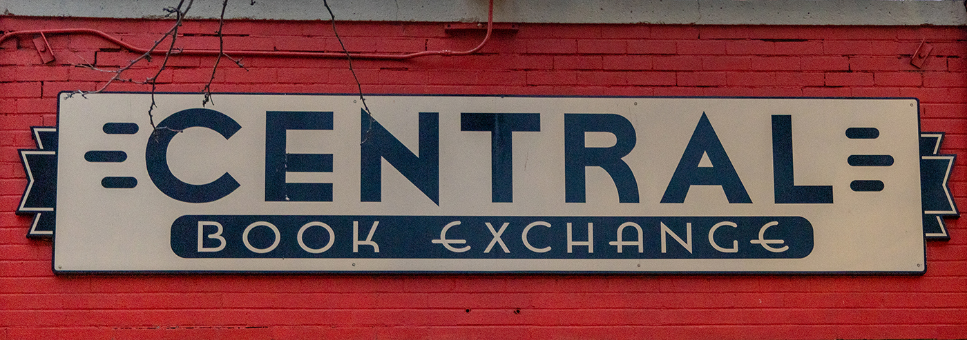 The Central Book Exchange sign sits atop a bright red brickface.