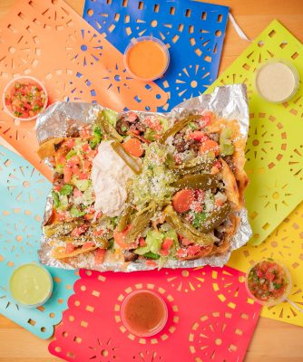 The Carne Asada Nachos at Real Taqueria gain a unique element with the addition of pickled vegetables as a topping.