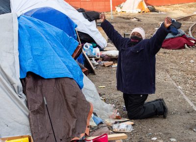 Homeless advocate, Ty Bellamy, with Back Lives for Humanity, reacts as she is told by one of the residents of Camp Last Hope, that he is going to detox, as she goes from tent to tent to remind everyone that they need to vacate the area tonight, on Wednesday, Feb. 3, 2021.