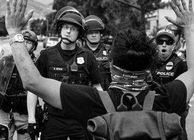 Salt Lake City Police warn a protester not to take a step further, as crowds were pushed back block after block, during a protest of the killing of George Floyd on Saturday, May 30, 2020.