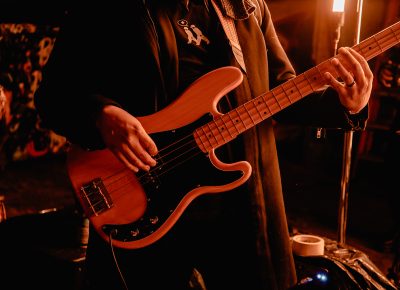 A member of Joshy's backing band performs at FICE Gallery's Black History Month Gallery Show.