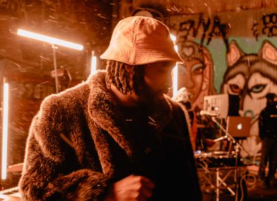 Donning a bucket hat, Younga$$ Nico pauses during his set.