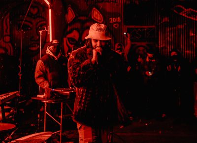 The neon lights add even more vibrancy to Younga$$ Nico's performance at FICE Gallery's Black History Month Gallery Show.