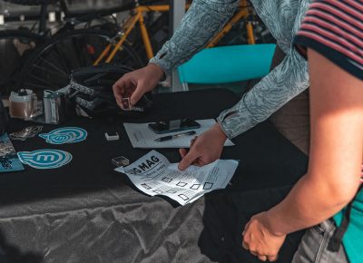 A racer receives their stamp from Magnum Bikes.