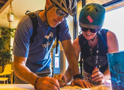 9th Annual SLUG Cat Participants race to finish their coloring book sheet at the Watchtower Cafe Checkpoint.