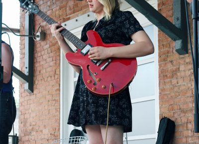 Audrey Lockie playing guitar in The Mercy Seat.