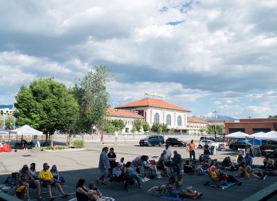 In the cool of the shade, the audience eagerly awaits the night's show.