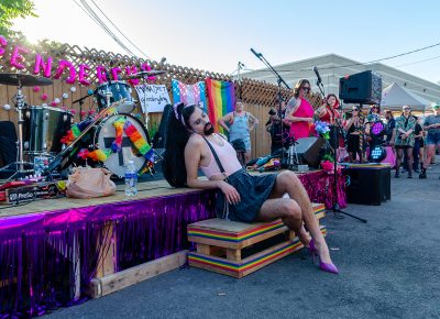 Genderfuq's first performer, Mona Diet, sits before the crowd, ready to deliver a show.