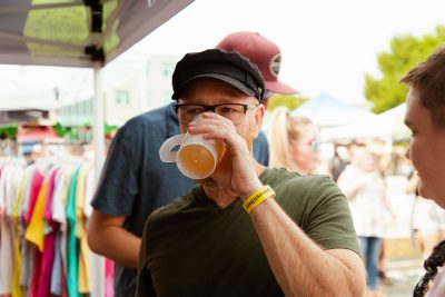 A satisfied Brewstillery attendee sips on their sample.