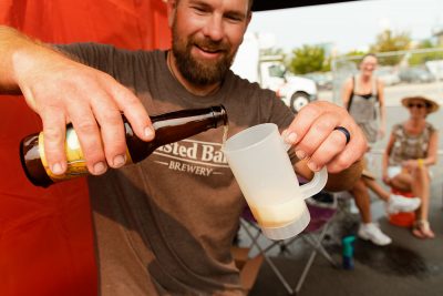 Toasted Barrell Brewery carefully pouring a sample of their signature sour beers.