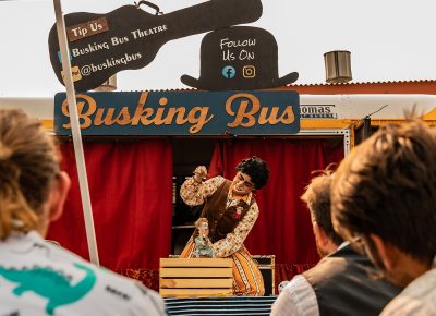 Spectators look on as performer LadyFingers does what they do best.