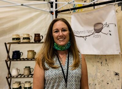 Robynn's Nest Pottery enjoying the afternoon at her booth in the Dreamers building.