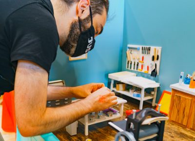 A CLC guest puts his hands to the test at Trishelle Jeffery’s miniature art display.