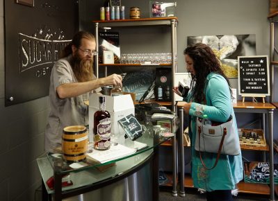 Employee Richard Malyn packs liquor and merch for a guest.