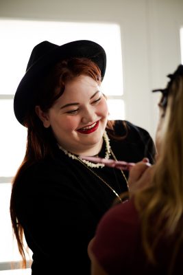 Abigail Marie Nielson working her magic on her model, Presley Lucas.