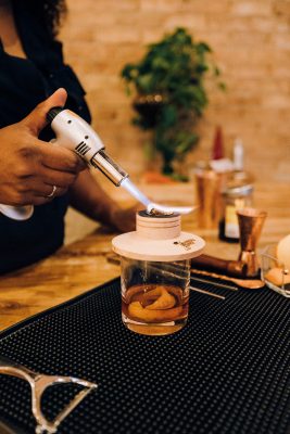 Alexi Fisher keeps her cocktail-making practices green by using eco-friendly practices and biodegradable materials.