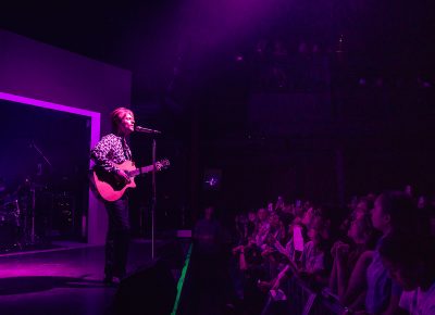 FINNEAS playing in a dimly lit, moody show start with the audience hanging on every word.