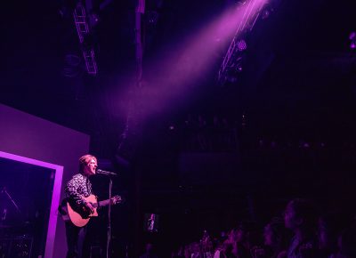 FINNEAS playing in a lone spotlight while on stage at the Depot in SLC.