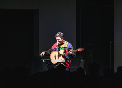 Marinelli playing on stage at the Depot in SLC, taking a break during songs to talk with the audience.