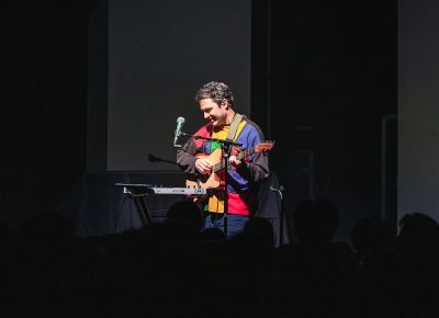 Marinelli strumming away during a one man set on stage at the Depot in SLC.