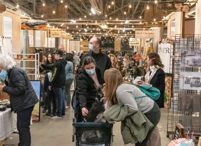 Patrons browse within the busy Holiday Market walkways.