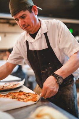 Pizza chef preparing pizzas at Oakwood Fire Kitchen