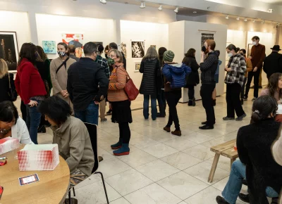 Exhibit goers enjoying conversation and the art.