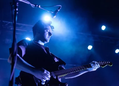 Guitarist Joseph Morinelli bathes in blue on stage at the Complex in SLC.