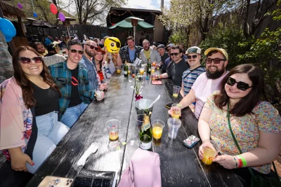 BYU alumni pose at a table while sipping their drinks at Bunny Hop.