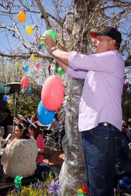 Interior Designer Rivers standing next to a tree at Bunny Hop.